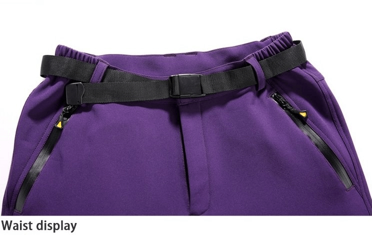 Close-up of purple hiking pants waist with adjustable belt and zipper pockets, showcasing windproof and waterproof features.